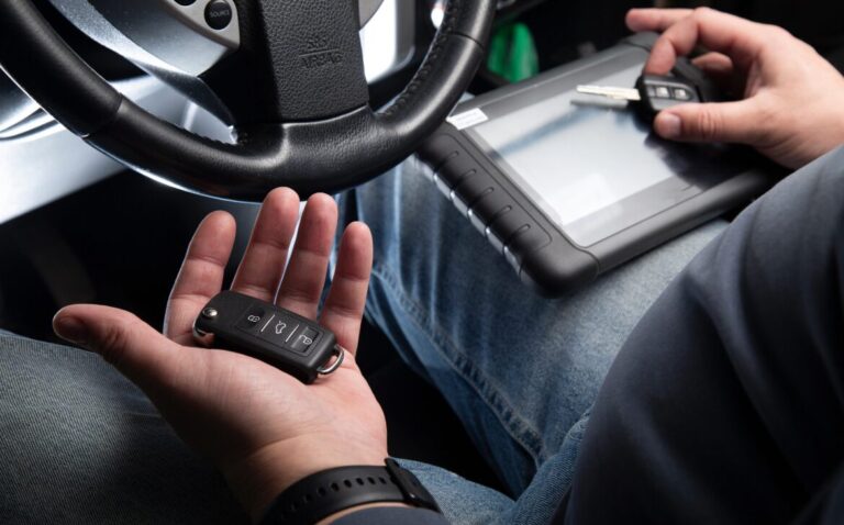Technician programming car keys for mobile fleet locksmith services in Atlanta.